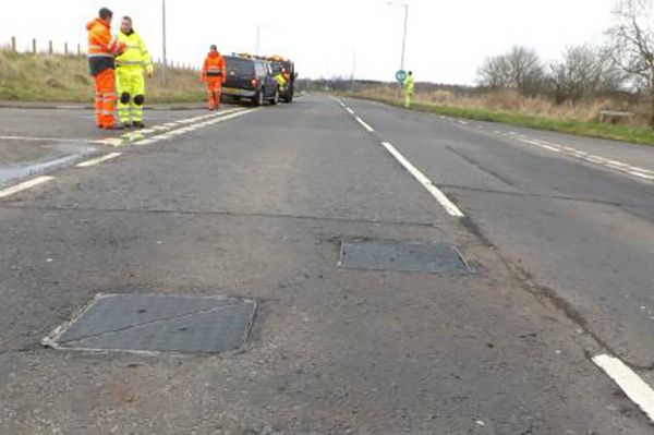 Preformed road markings making manhole covers safer