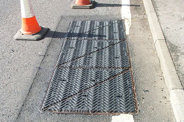 Non-slippery manhole cover with preformed markings